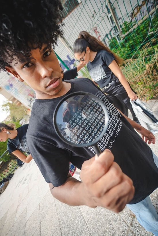 Person holding a magnifying glass with a blurred background
